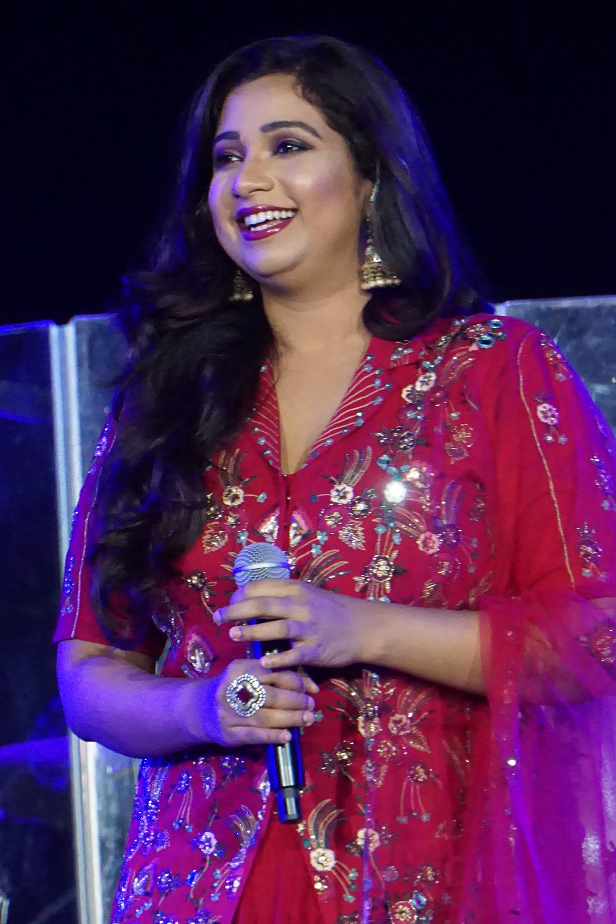 Shreya Ghoshal in Cherry Red Jacket Skirt Set